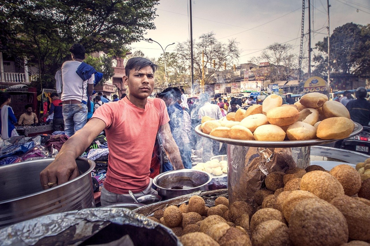 A street food vendor on a busy Old Delhi street
