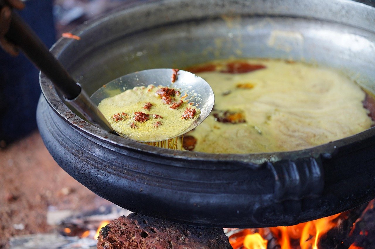 Street food frying in hot oil at an Old Delhi stall